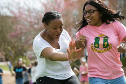 Two students run together. 