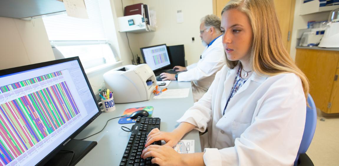 Cat Gambill '17 and Dr. Dale Beach in the lab, reviewing DNA study results