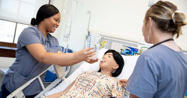 Nursing Students tending to a patient in the simulation lab