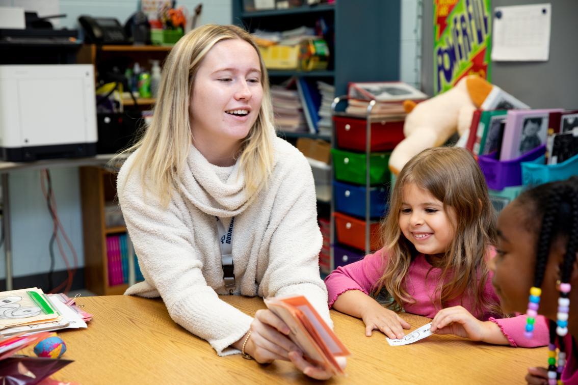 Student teacher in classroom with some elementary school students